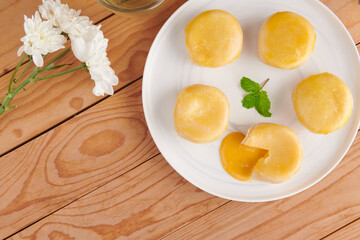Chinese Dessert Traditional, Sweet Dessert Chinese Style, Asian Dessert. Plate of delicious homemade Chinese pastry with stuffed salted egg yolk lava, selective focus.