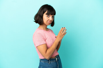 Young mixed race woman isolated on blue background scheming something