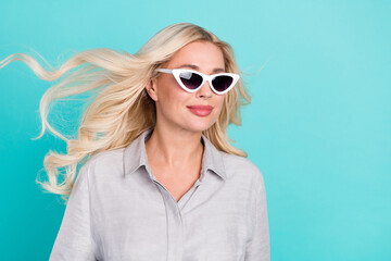 Profile photo of sincere positive lovely lady look empty space wear sunglass grey shirt isolated teal color background