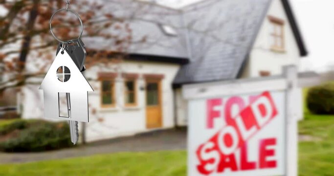 Animation of silver house key fob and key, hanging in front of blurred house with sold sign