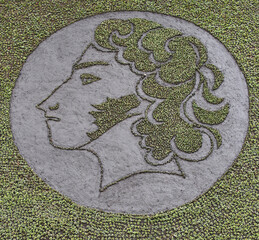 A panel of plants grazing the profile of A.S. Pushkin.