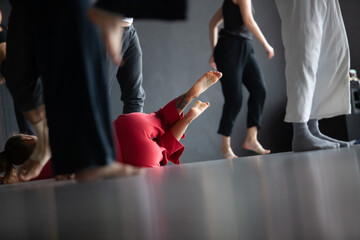 several dancers move on floor n contact improvisation performance intentionally with motion blur ond defocus bokeh