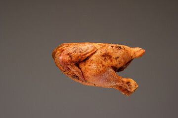 Fresh whole chicken, raw and ready seasoned. Close up studio shot, isolated on brown background