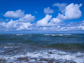 Fototapeta na wymiar vivid seascape, beautiful sea with waves and blue sky with white clouds, natural background
