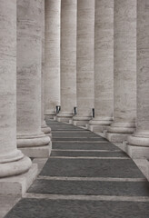 Fototapeta premium The row of round stone columns. Passage between columns.