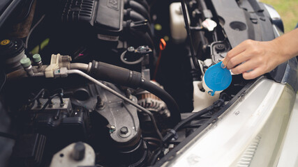 Woman checking engine condition. Car. Car maintenance concept.