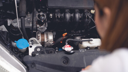 Woman checking engine condition. Car. Car maintenance concept.