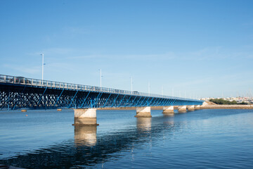 Obraz premium Beautiful old blue bridge over Arade river at Portimao. Cars crossing, Portugal, Europe