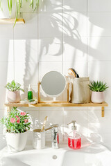 Bright and white modern bathroom with bamboo shelf and a sink next to a window at sunny day. Shadows on the white tile wall. Zero waste and sustainable life style. Wellness