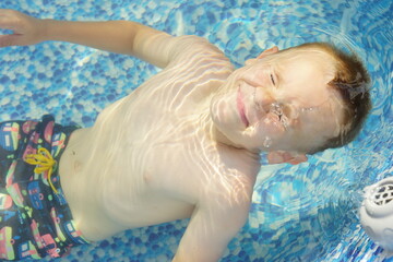 Child In a swimming pool. Under water. Refreshing. Security. Summer. Seasonal 