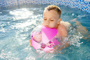 baby in the pool. Summer refreshing procedure. Water. Sunny Day 