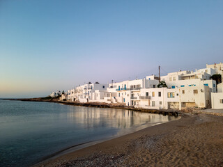 Fototapeta na wymiar Paros island, Greece, Cyclades. Naousa city panoramic view, advertisement. Sandy beach calm sea.