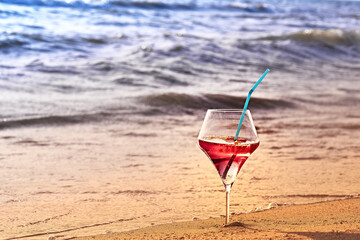 Wine glass with a cocktail by the sea.