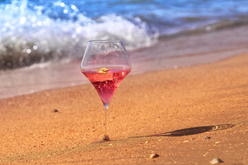 Wine glass with a cocktail by the sea.