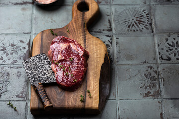 Slices of steak on dark wooden board