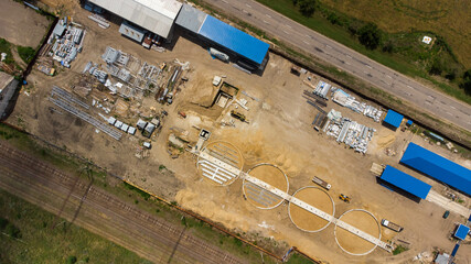 Aerial view of modern grain elevator. Wheat storage building, building in progress. Silo farm. Agribusiness development construction.