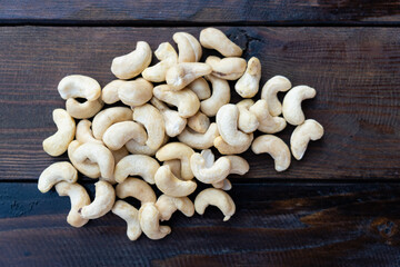 Raw cashew nuts on a wooden table close-up