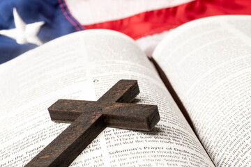 Small wooden cross on Bible