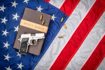 Gun on Holy Bible with American Flag