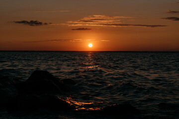 Photo of a Summer Sunset on the Lake. Travel location of popular tourist outdoor. View of beautiful Sea Landscape. Relax vacation near water