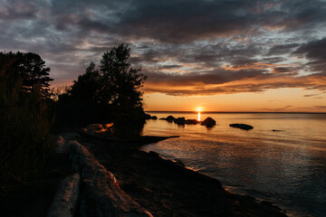 Photo of a Summer Sunset on the Lake. Travel location of popular tourist outdoor. View of beautiful Sea Landscape. Relax vacation near water