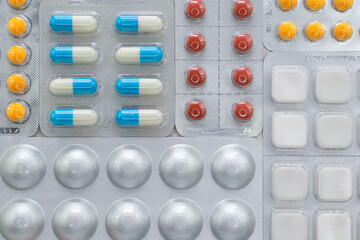 Various pills in many blisters. Medical concept background.