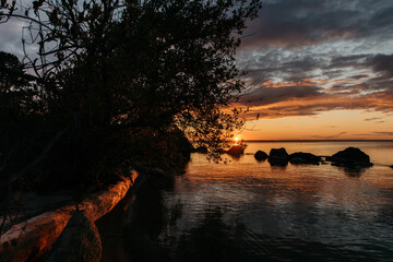 Photo of a Summer Sunset on the Lake. Travel location of popular tourist outdoor. View of beautiful Sea Landscape. Relax vacation near water