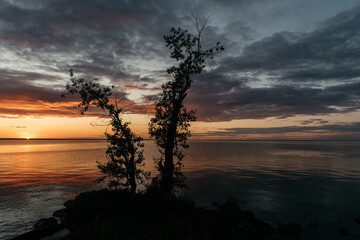 Photo of a Summer Sunset on the Lake. Travel location of popular tourist outdoor. View of beautiful Sea Landscape. Relax vacation near water