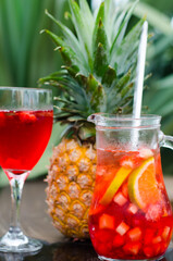 Jar and Glass with a pineapple in the back