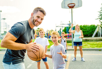 Happy basketball family portrait play this sport on summer season
