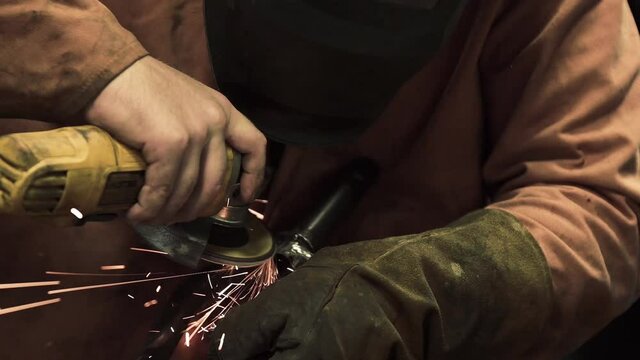 c&aacute;mara lenta de un hombre con un esmeril en sus manos con guantes