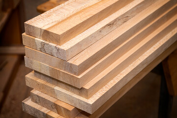 Stack of planed oak boards ready to be made into furniture - obrazy, fototapety, plakaty