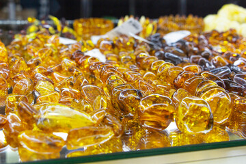 Beautiful jewelry made of natural amber. Jewelry made of amber yellow orange color, close-up.