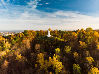 Aerial view of the Three Crosses monument overlooking Vilnius Old Town on sunset. Vilnius landscape from the Hill of Three Crosses, Lithuania