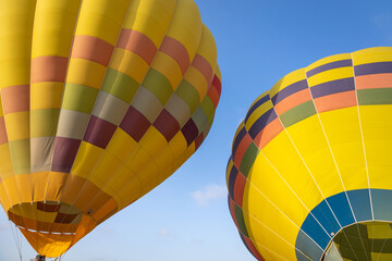 Colorful yellow and red hot air balloons over blue sky in California