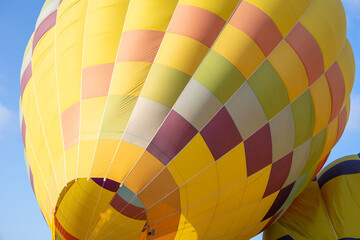 Colorful yellow and red hot air balloons over blue sky in California