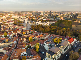 Beautiful Vilnius city panorama in autumn with orange and yellow foliage. Aerial evening view. Fall city scenery in Lithuania