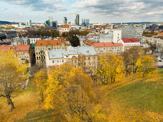 Beautiful Vilnius city panorama in autumn with orange and yellow foliage. Aerial evening view. Fall city scenery in Lithuania