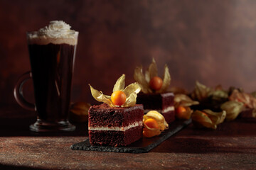 Chocolate cake with physalis on a brown background.