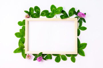 White paper frame text. Flat surface, white background. With clover petals