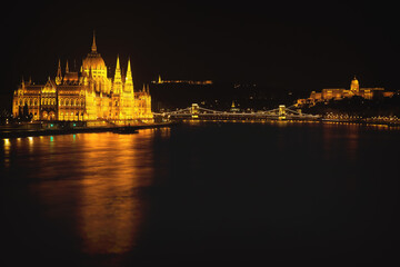 Hungarian Parliament Building located at the bank of Dunabe river with famous Chain Bridge connecting Buda and Pest in Budapest, Hungary