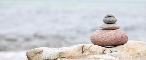stack of stones on beach with sun light