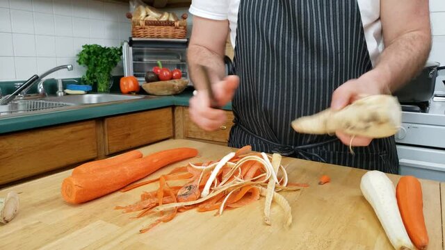Home cooking - Trimming and cleaning vegetables like carrot parsley or parsnip and celery preparing for cooking.