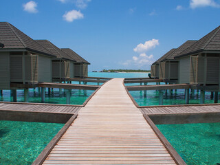 Wooden bungalow on the coast of the Maldives on a sunny day. Copy space for text.