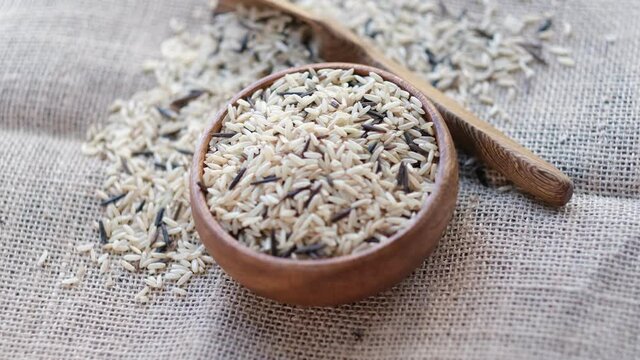 mix black wild and brown rice rotating. Close up video. top view. Slow motion video. stock footage.