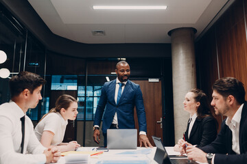 Black boss mentor Businessman and team at office corporate meeting. Business people group conference discussion sit at table