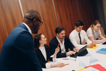 Businessman african boss and businesswoman team at office meeting. Business people group conference discussion sit at table with boss man and woman