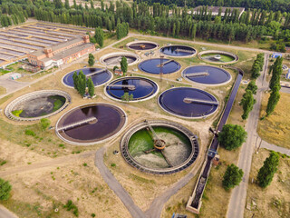 Round wastewater cleaning reservoirs at a sewage treatment facility. Grey water recycling, aerial view