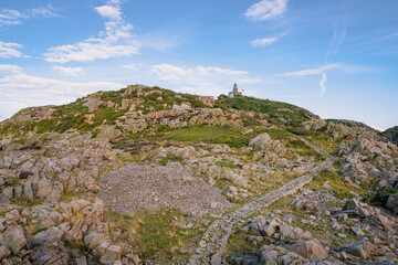 Lighthouse on the rocky coast at Kullaberg nature reserve in south Sweden. Popular tourist destination.