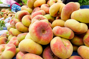 Fresh ripe flat peaches harvested from the orchard